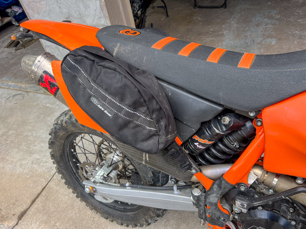 OBR 10L Saddlebag on Dual Sport motorcycle, cradle straps under seat.