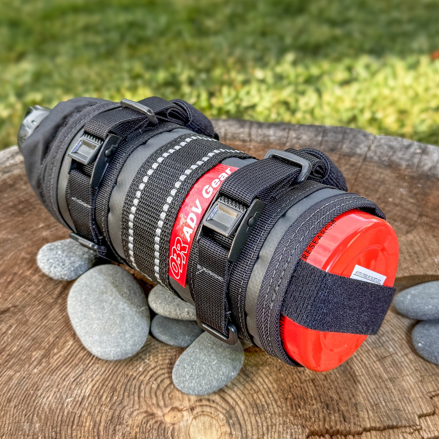 Adjustable motorcycle bottle wrap for camping and ADV travel, with reflective webbing